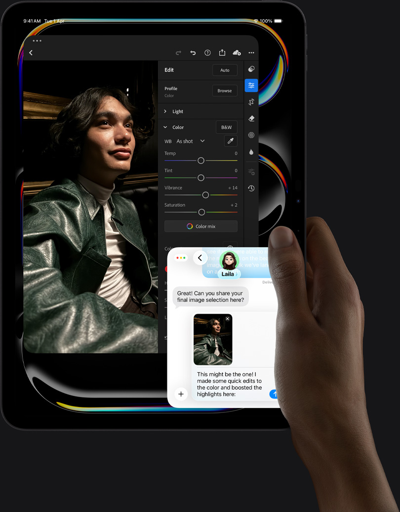 iPad Pro, front exterior, portrait orientation, space black color, right hand holding device, display showing photo editing app with image of a person in a blue outfit, editing tools and options in right menu, at bottom-right of display an iMessage conversation is happening between user and another individual reviewing the photo