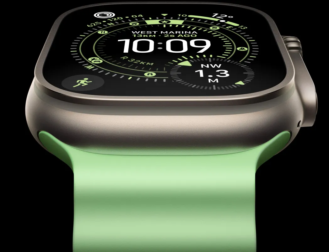 Apple Watch Ultra 3，採用原色鈦金屬錶殼，配以霓虹綠色海洋錶帶，螢幕顯示定向運動錶面的指南針
