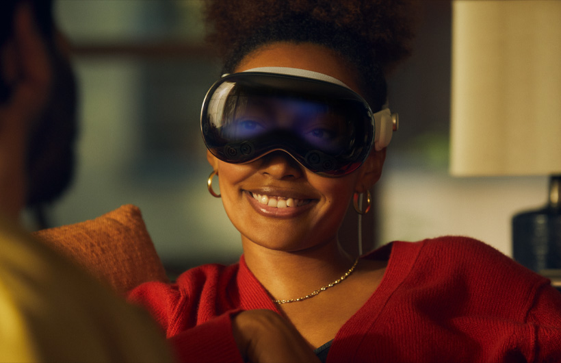 Person wearing Apple Vision Pro, eyes visible through front exterior glass