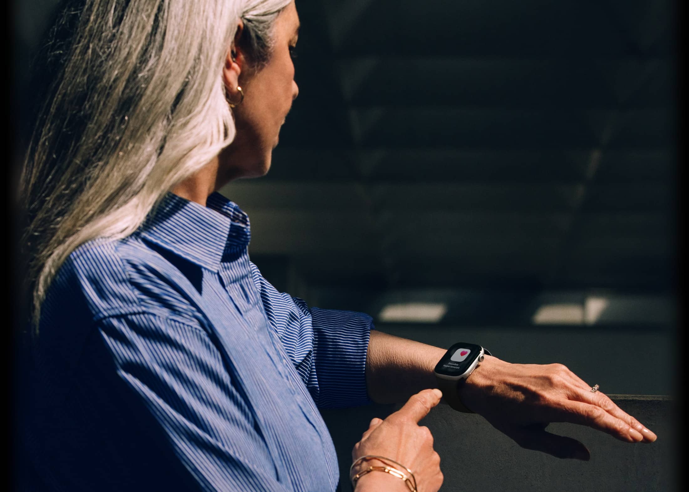 A person reads a hypertension notification on their Apple Watch Series 11