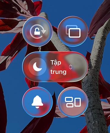 Colorful iPhone home screen with transparent Liquid Glass apps and widgets